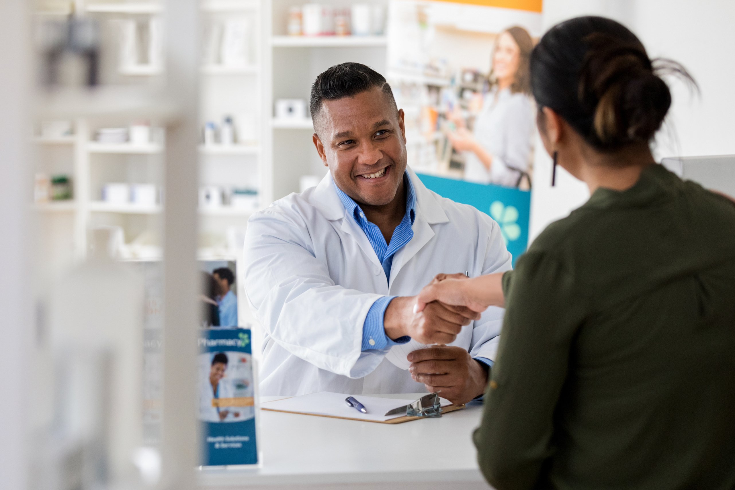 Pharmacist greets customer